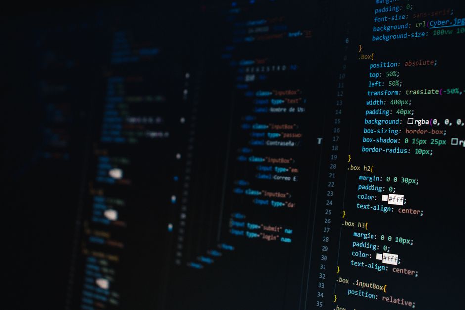 Laptop with programming code on screen