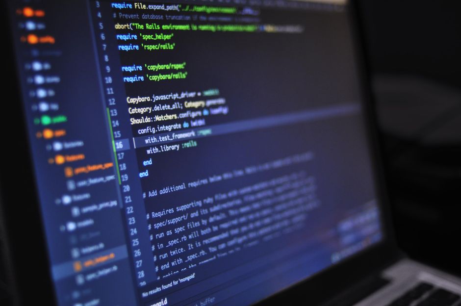 Laptop displaying code editor with syntax highlighting